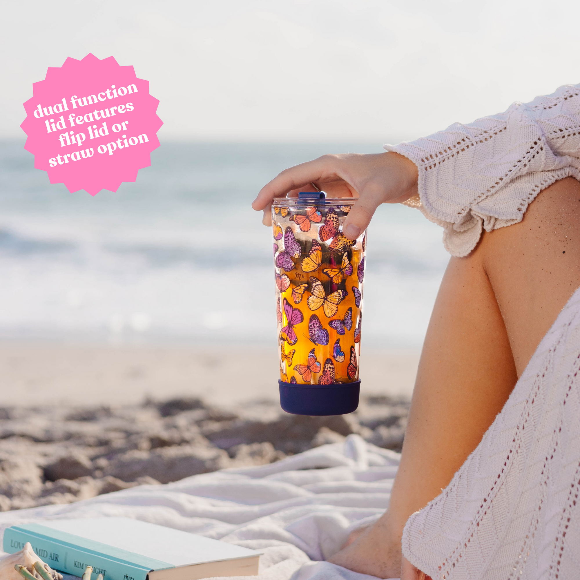 Hand holding a 20oz butterfly-designed double-wall glass cup with text: 'Dual function lid features flip lid or straw option.'